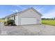 View of garage and landscaping on bright day at 9605 W 100 S, Jamestown, IN 46147