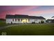 Charming home with a well-maintained lawn and a long driveway, set against a vibrant sunset backdrop at 9605 W 100 S, Jamestown, IN 46147