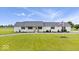 Inviting single-story home featuring a manicured lawn, complemented by an American flag for a patriotic touch at 9605 W 100 S, Jamestown, IN 46147