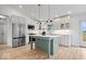 Well-lit kitchen with stainless steel appliances, an island with a marble countertop, and light wood floors at 9605 W 100 S, Jamestown, IN 46147