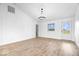 Bright living room featuring light wood floors, a modern chandelier, and a large window with a view at 9605 W 100 S, Jamestown, IN 46147