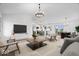 Bright open-concept living space with modern furnishings, flowing into the kitchen and dining area at 9605 W 100 S, Jamestown, IN 46147