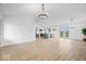 Open-concept living space offers light wood floors and a view of the modern kitchen and dining area at 9605 W 100 S, Jamestown, IN 46147