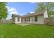 The home's backyard has a patio and a large green lawn at 975 Atir Ln, Greenfield, IN 46140