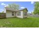 A well-maintained backyard featuring green grass and a classic home exterior, perfect for outdoor relaxation and activities at 975 Atir Ln, Greenfield, IN 46140