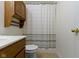 This bathroom features a toilet, shower and vanity with storage at 975 Atir Ln, Greenfield, IN 46140