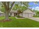 Charming single-story home featuring a manicured lawn, two-car garage, and inviting curb appeal at 975 Atir Ln, Greenfield, IN 46140