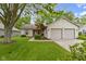 Charming single-story home featuring a manicured lawn, two-car garage, and inviting curb appeal at 975 Atir Ln, Greenfield, IN 46140
