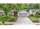 Inviting single-story home with a well-maintained lawn, a two-car garage and a welcoming front entrance at 975 Atir Ln, Greenfield, IN 46140