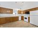 Functional kitchen with ample wooden cabinets, white appliances, and a spacious layout at 975 Atir Ln, Greenfield, IN 46140
