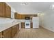 Functional kitchen with ample wooden cabinets, white appliances, and a spacious layout at 975 Atir Ln, Greenfield, IN 46140