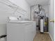 This laundry room includes a washer, dryer and shelving for storage at 975 Atir Ln, Greenfield, IN 46140