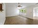 Inviting living room featuring wood floors, large windows, and a ceiling fan with lights at 975 Atir Ln, Greenfield, IN 46140