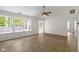 Bright living room featuring wood floors, large windows, and a ceiling fan for comfortable living at 975 Atir Ln, Greenfield, IN 46140