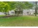 Backyard featuring screen-in porch, grassy yard, and mature trees at 10501 Greenway Dr, Fishers, IN 46037