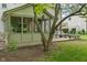 Backyard featuring deck, screened-in porch, mature trees, and green lawn at 10501 Greenway Dr, Fishers, IN 46037