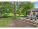 Relaxing backyard scene with deck, outdoor seating, and lush greenery at 10501 Greenway Dr, Fishers, IN 46037