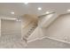 Finished basement featuring neutral paint, carpet, and staircase access at 10501 Greenway Dr, Fishers, IN 46037