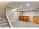 Finished basement with bar area, wood cabinets, and seating for entertaining at 10501 Greenway Dr, Fishers, IN 46037