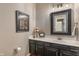 Stylish half bathroom featuring a black framed mirror and modern vanity at 10501 Greenway Dr, Fishers, IN 46037