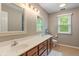 Bright bathroom with dual sinks, wooden cabinets, and a well-lit vanity mirror at 10501 Greenway Dr, Fishers, IN 46037