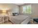 Cozy bedroom featuring a bed with decorative pillows and a side table with lamp at 10501 Greenway Dr, Fishers, IN 46037