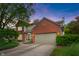 Charming two-story home featuring a brick facade, attached garage, and beautifully landscaped front yard at 10501 Greenway Dr, Fishers, IN 46037