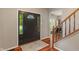 Open foyer featuring hardwood floors, staircase, and front door with decorative glass at 10501 Greenway Dr, Fishers, IN 46037