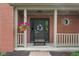 Inviting front entrance with a black door, decorative wreath, sidelights, and hanging flower basket at 10501 Greenway Dr, Fishers, IN 46037