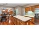 Open kitchen with an island, oak cabinets, and stainless steel appliances adjoining the dining room at 10501 Greenway Dr, Fishers, IN 46037