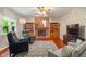 Relaxing living room with brick fireplace, hardwood floors, and comfortable seating at 10501 Greenway Dr, Fishers, IN 46037