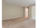 Bright living room with neutral walls, carpet flooring, and multiple doors at 10501 Greenway Dr, Fishers, IN 46037