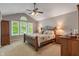 Spacious main bedroom with vaulted ceilings and bright windows overlooking the yard at 10501 Greenway Dr, Fishers, IN 46037