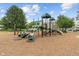 Community playground featuring slides, climbing structures and benches, surrounded by trees at 10501 Greenway Dr, Fishers, IN 46037