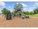 Community playground featuring slides, climbing structures and benches on a mulch surface at 10501 Greenway Dr, Fishers, IN 46037