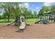 Community playground featuring slides and climbing structures, set on a mulch surface with green grass surrounding at 10501 Greenway Dr, Fishers, IN 46037