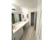 Bright bathroom featuring a white dual sink vanity with modern fixtures and mosaic tiled floor at 1056 Bent Branch Ln, Greenwood, IN 46143