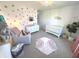 Bright and airy Bedroom with crib, dresser, and stylish decor at 1056 Bent Branch Ln, Greenwood, IN 46143