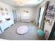 Light filled Bedroom with a white crib, large window with book shelves and soft gray carpet at 1056 Bent Branch Ln, Greenwood, IN 46143