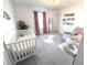 Charming Bedroom with crib, rocking chair, and stylish decor at 1056 Bent Branch Ln, Greenwood, IN 46143
