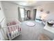 Bright Bedroom with a white crib, natural light from a large window and light pink walls at 1056 Bent Branch Ln, Greenwood, IN 46143