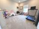 Carpeted bonus room with treadmill and toys at 1056 Bent Branch Ln, Greenwood, IN 46143