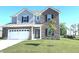Beautiful two-story home with brick and vinyl siding, complemented by a green lawn and vibrant landscaping at 1056 Bent Branch Ln, Greenwood, IN 46143