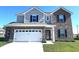 Charming two-story home featuring a brick and vinyl facade, attached garage, and well-maintained landscaping at 1056 Bent Branch Ln, Greenwood, IN 46143