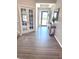 Welcoming foyer with gray wood-look floors, decorative table, and glass paneled French doors at 1056 Bent Branch Ln, Greenwood, IN 46143