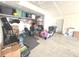 Functional garage storage featuring open ceiling, shelves, toys, and concrete flooring at 1056 Bent Branch Ln, Greenwood, IN 46143