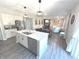 Bright kitchen features island with sink and stainless appliances in open concept living area at 1056 Bent Branch Ln, Greenwood, IN 46143
