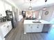 Open concept kitchen with modern island, stainless appliances, and adjacent living area at 1056 Bent Branch Ln, Greenwood, IN 46143