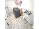 Practical laundry room with gray tile flooring, washer, dryer, and shelving at 1056 Bent Branch Ln, Greenwood, IN 46143