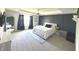 Spacious main bedroom featuring a tray ceiling, neutral carpet and large window with navy curtains at 1056 Bent Branch Ln, Greenwood, IN 46143